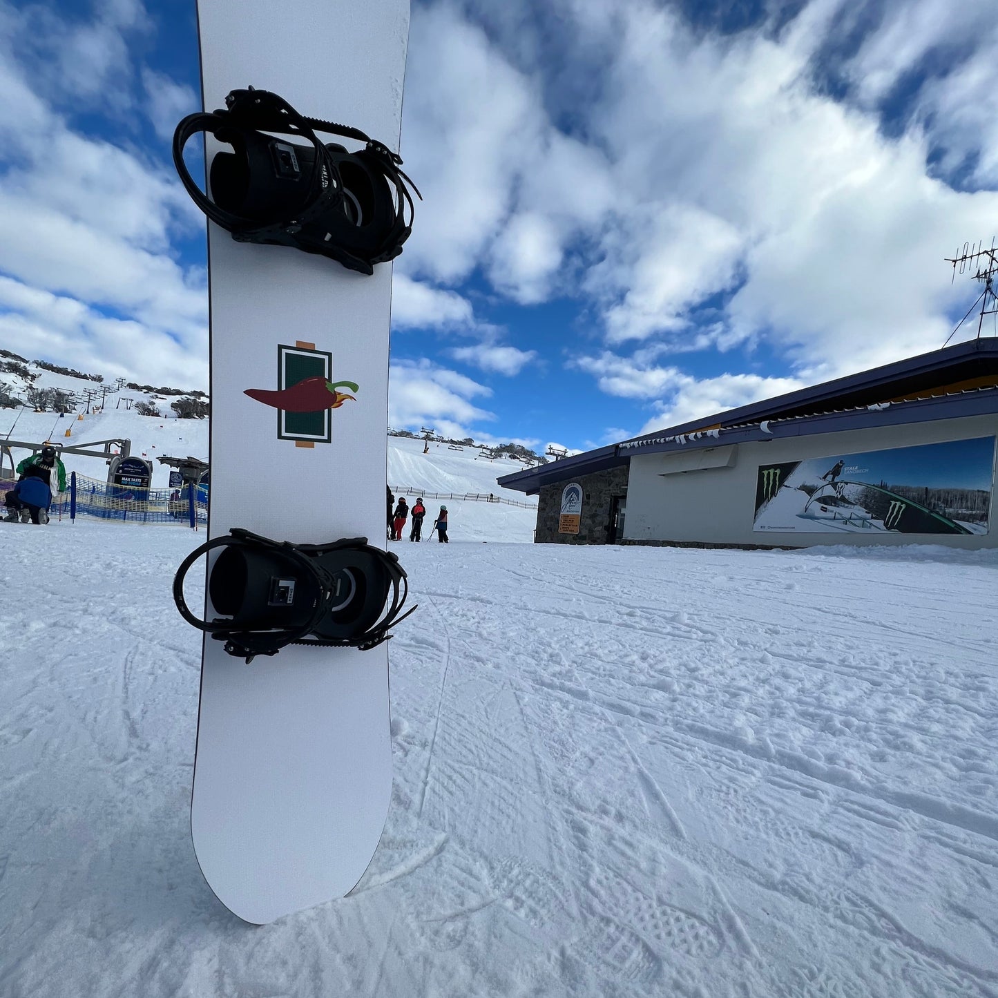 Top Sheet of RetroPRO custom twin shape snowboard on hill at Front valley Perisher Australia - Jalapeño Board Company | Custom Snowboards Australia