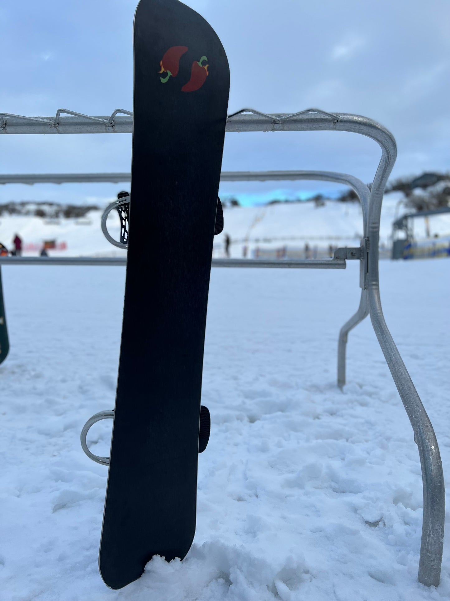 Base Graphic of Sakana custom powder shape snowboard on hill at Front valley Perisher - Jalapeño Board Company | Custom Snowboards Australia