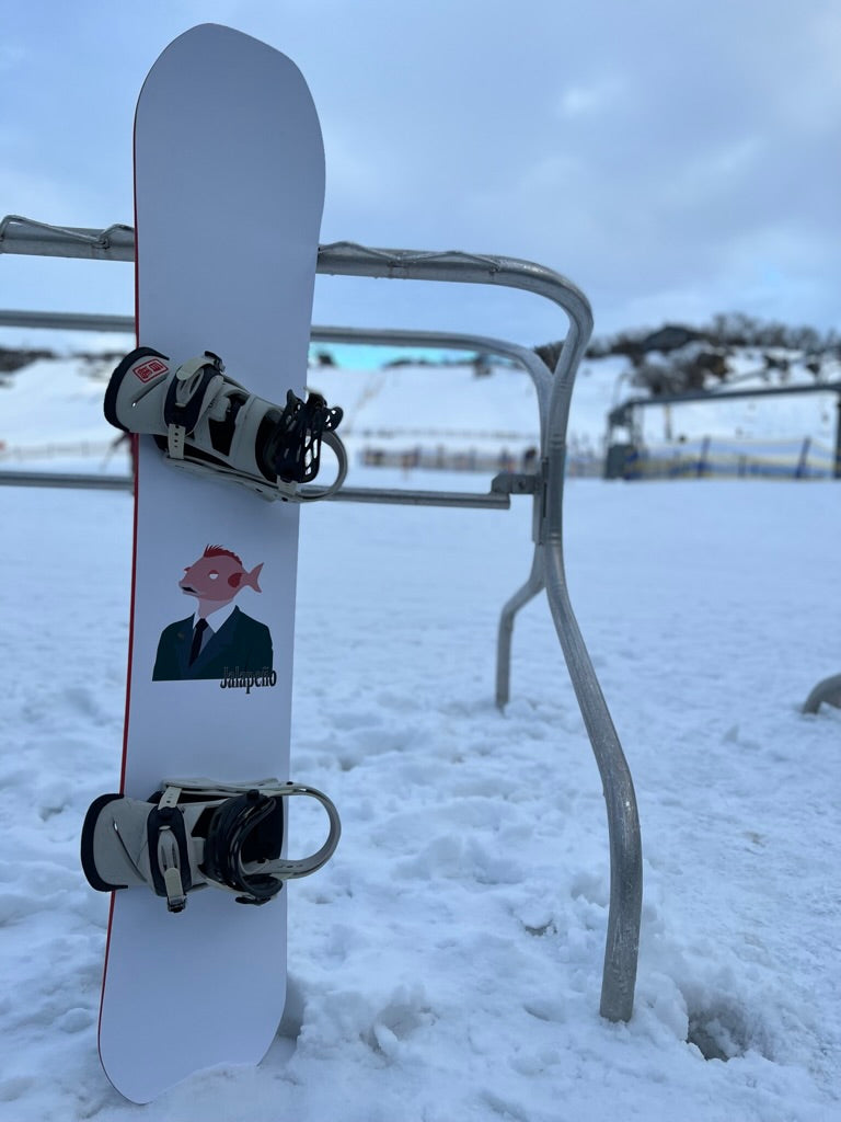 Top Sheet of Sakana custom powder shape snowboard on hill at Front valley Perisher - Jalapeño Board Company | Custom Snowboards Australia