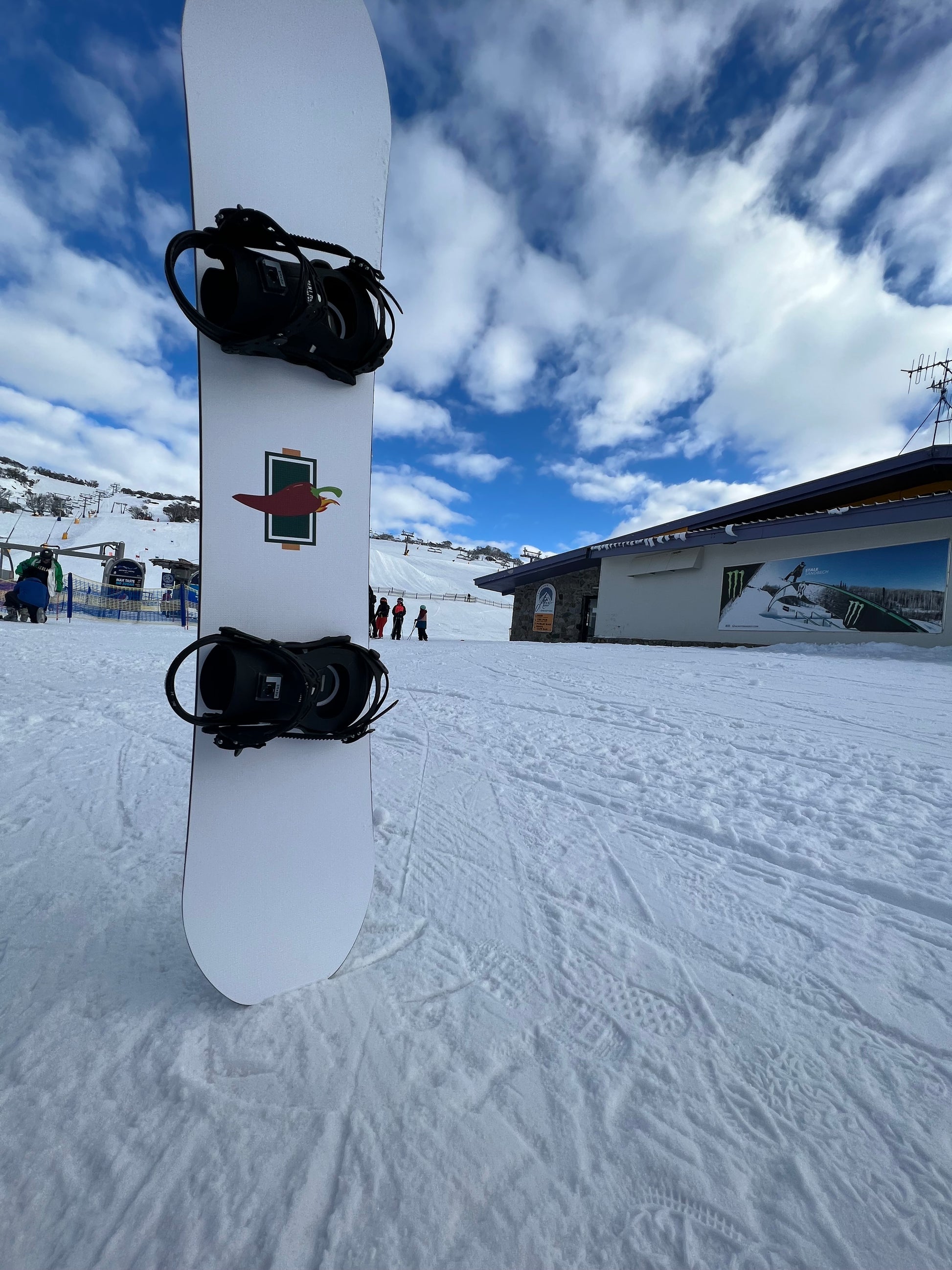 Top Sheet of RetroPRO custom twin shape snowboard on hill at Front valley Perisher Australia - Jalapeño Board Company | Custom Snowboards Australia